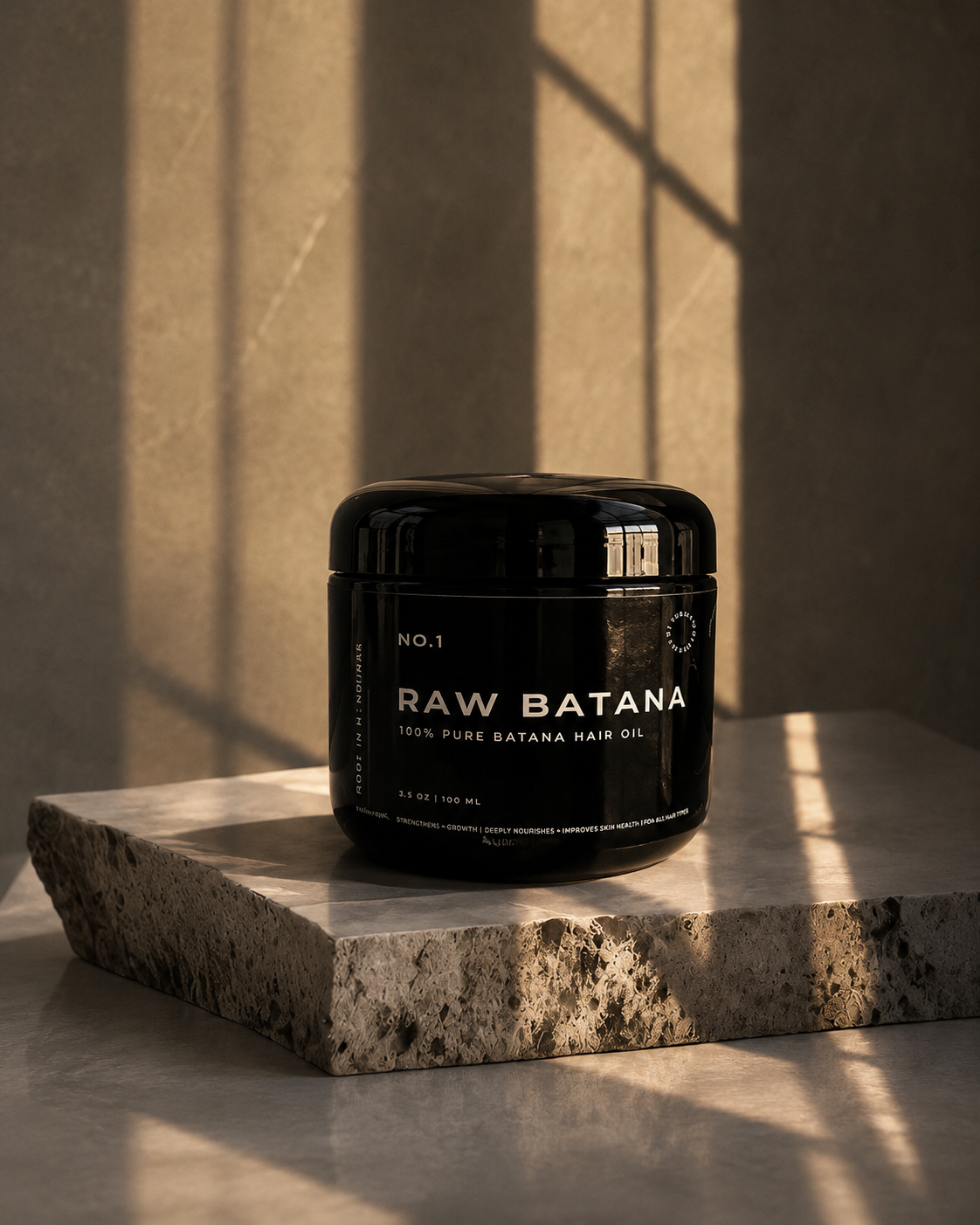 Raw Batana Oil jar on travertine stone in soft window light